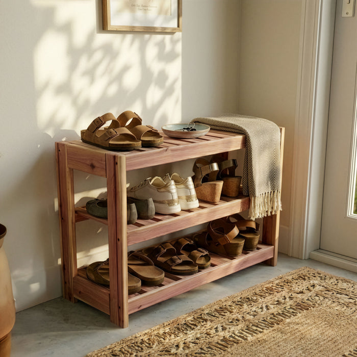 Wooden shoe rack with shoes and a blanket in a well-lit room.