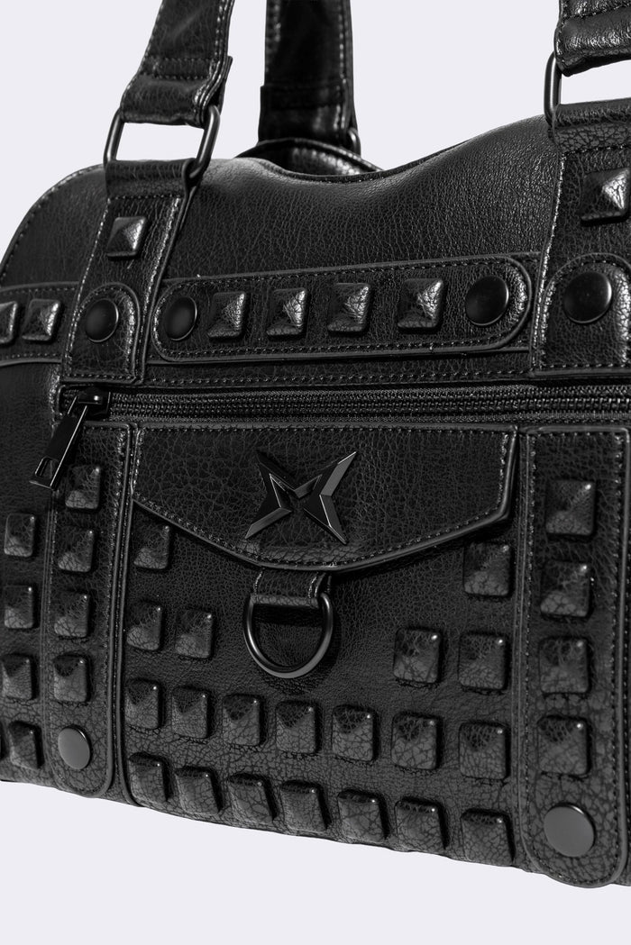 Black faux leather shoulder bag with pyramid studs, front zip pocket, side pockets and two top handles.