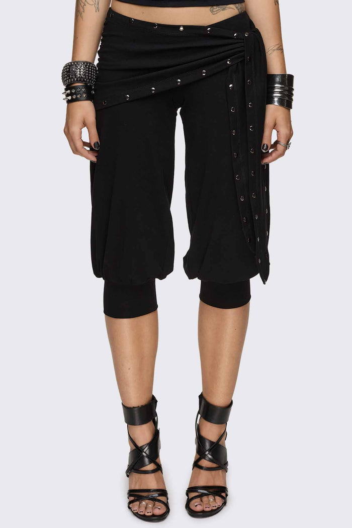Black capri pants with wrap overskirt tie detail, silver studs, balloon fit and elasticated cuffs.