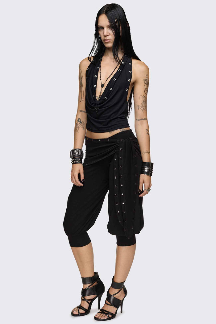 Black capri pants with wrap overskirt tie detail, silver studs, balloon fit and elasticated cuffs.