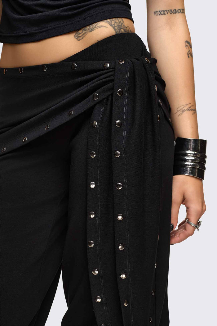 Black capri pants with wrap overskirt tie detail, silver studs, balloon fit and elasticated cuffs.