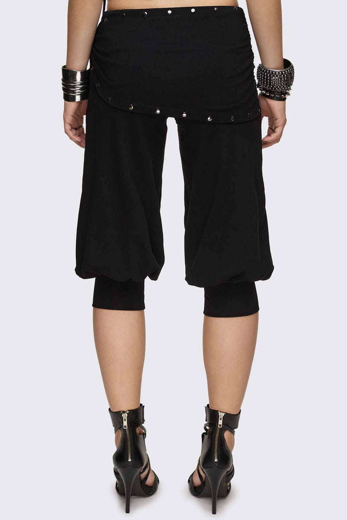 Black capri pants with wrap overskirt tie detail, silver studs, balloon fit and elasticated cuffs.