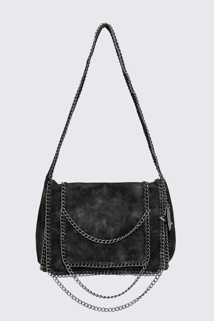 Black faux suede shoulder bag with chain trim, layered chains and fold-over flap in a grunge Y2K style.