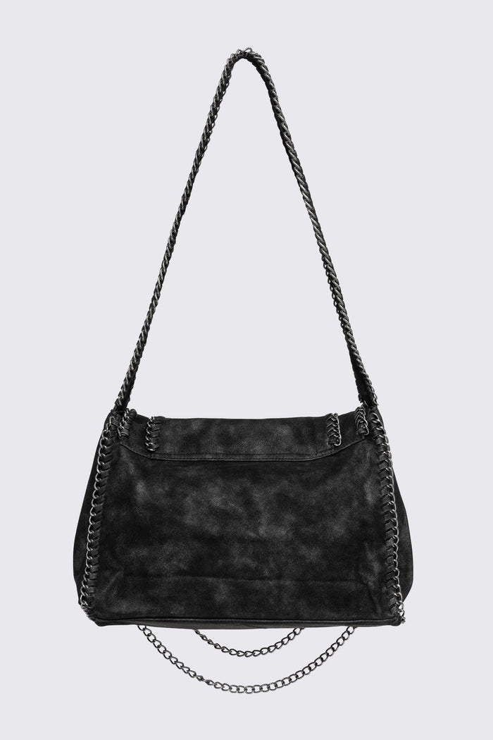 Black faux suede shoulder bag with chain trim, layered chains and fold-over flap in a grunge Y2K style.