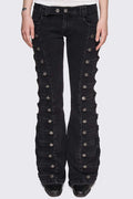 Black washed denim flare jeans with drummer-style button panels and military detailing in a dark grunge vibe.