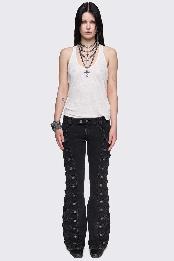 Black washed denim flare jeans with drummer-style button panels and military detailing in a dark grunge vibe.