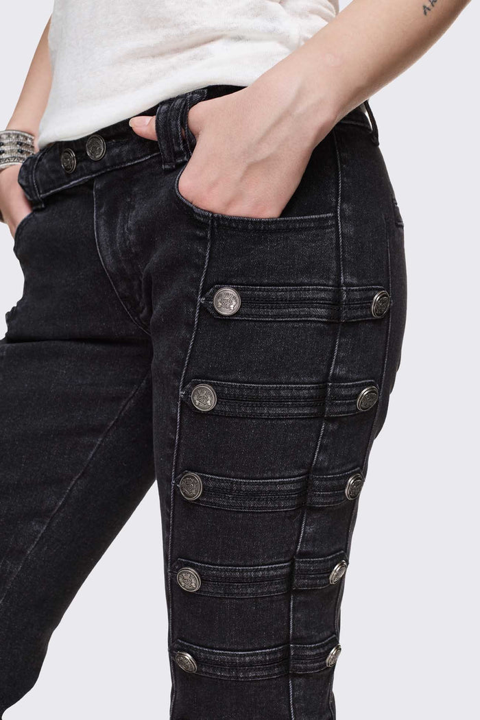 Black washed denim flare jeans with drummer-style button panels and military detailing in a dark grunge vibe.