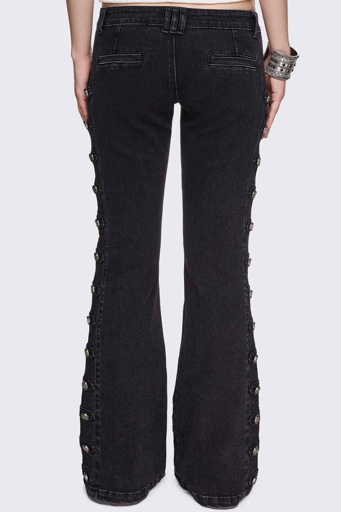 Black washed denim flare jeans with drummer-style button panels and military detailing in a dark grunge vibe.