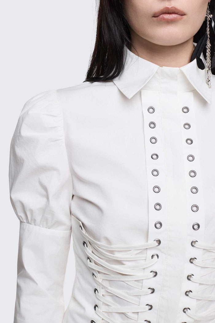 White cotton shirt with corset lace-up panels, puffed shoulders and eyelet details in a whimigoth style.