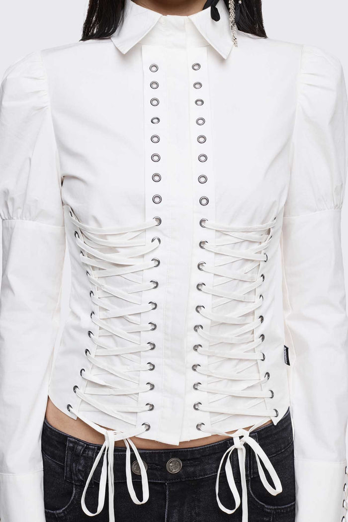 White cotton shirt with corset lace-up panels, puffed shoulders and eyelet details in a whimigoth style.