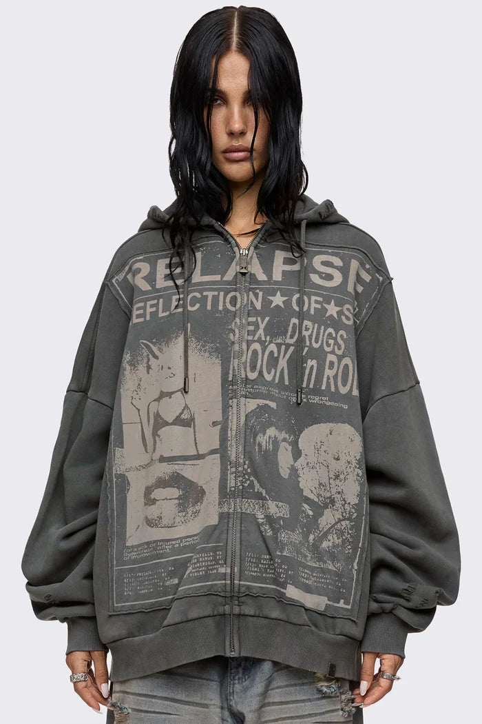 Grey washed zip up hoodie with Relapse graphic print, distressed details and oversized fit on model.
