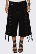 Black washed denim jorts with lace-up corset sides, baggy wide-leg fit and grunge aesthetic.