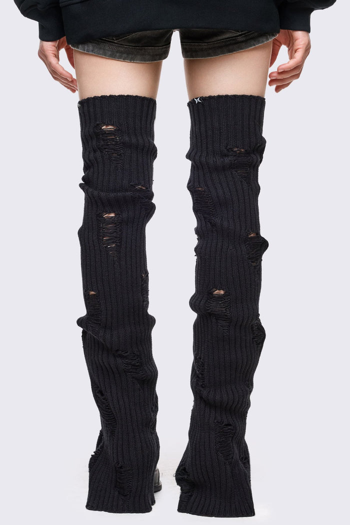 Black rib-knit thigh-high leg warmer with shredded distressed details in a grunge style.