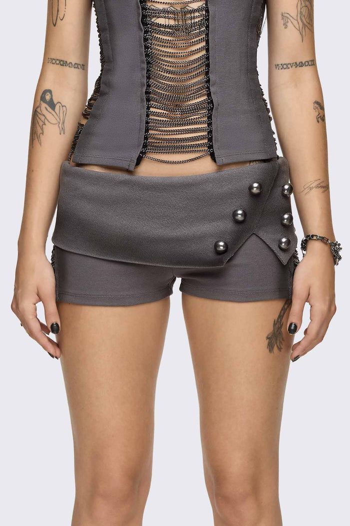Grey washed jersey hot pants with side cutouts, silver chains and a studded fold-over low rise waistband.